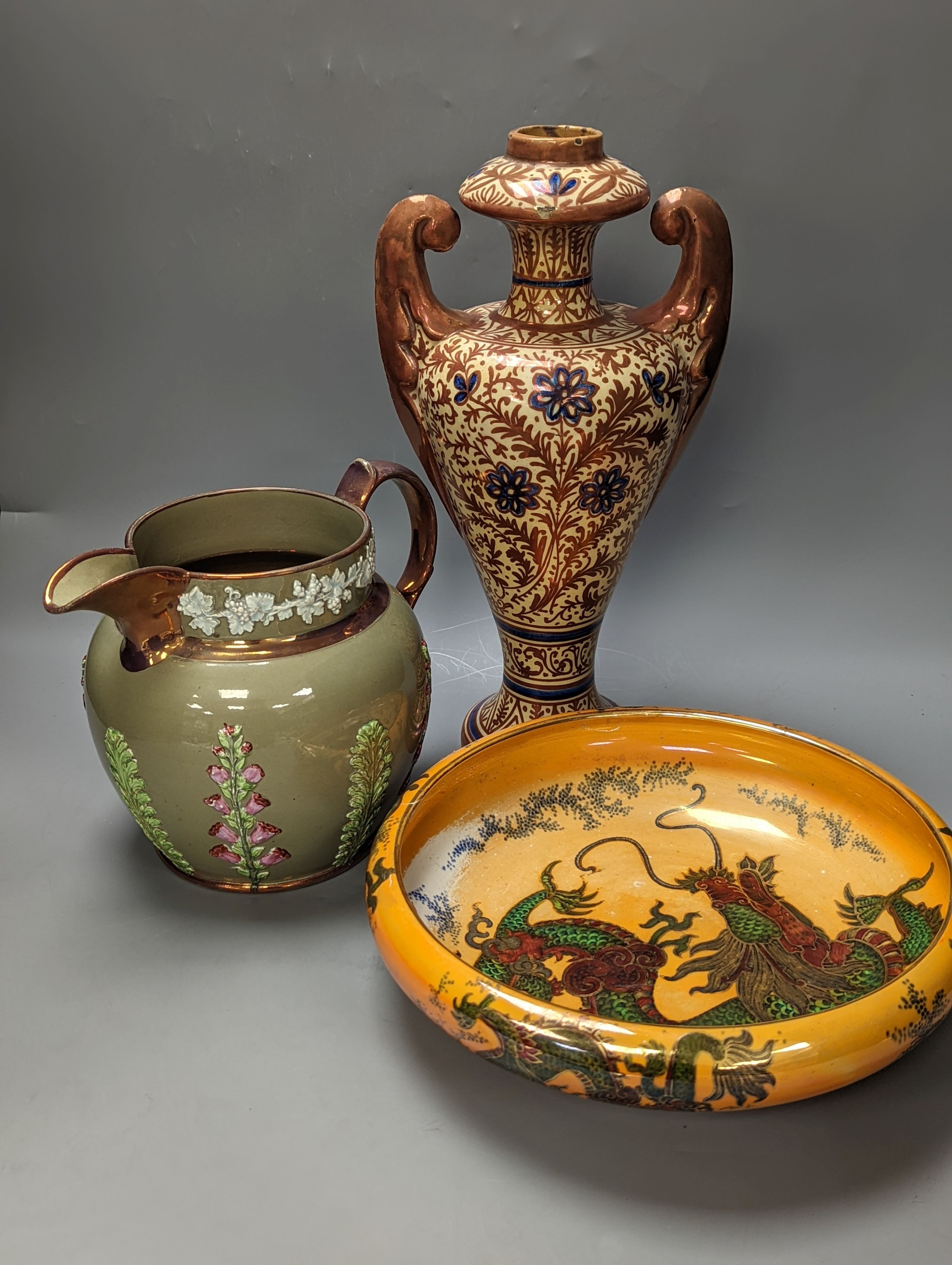A Burley ware lustre dragon bowl, a lustre and fox glove designed jug and a Hispano-Moresque style copper lustre vase, Vase 38 cms high.